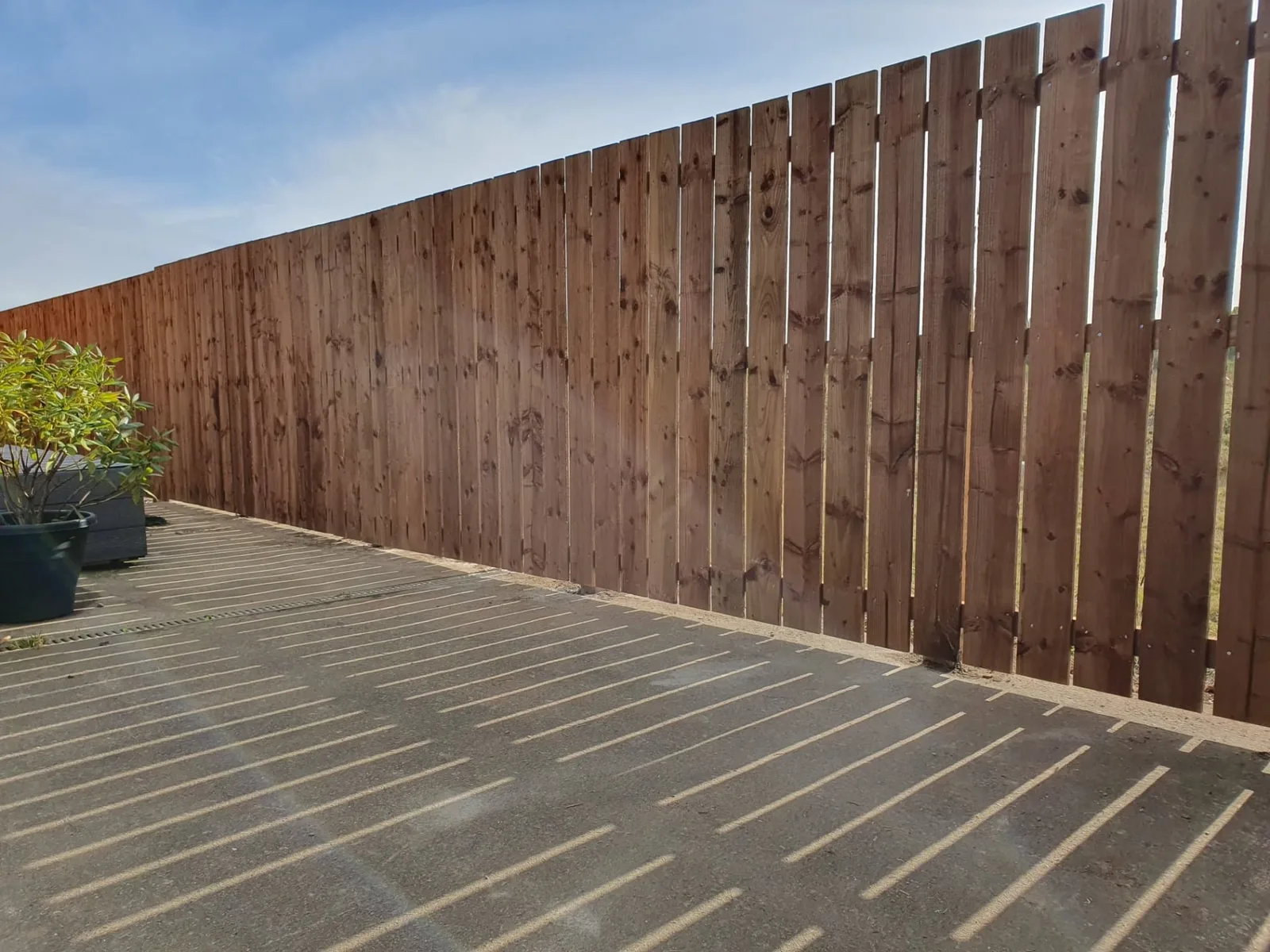 Tall new timber fencing installed alongside a sunny deck by JBEEZ