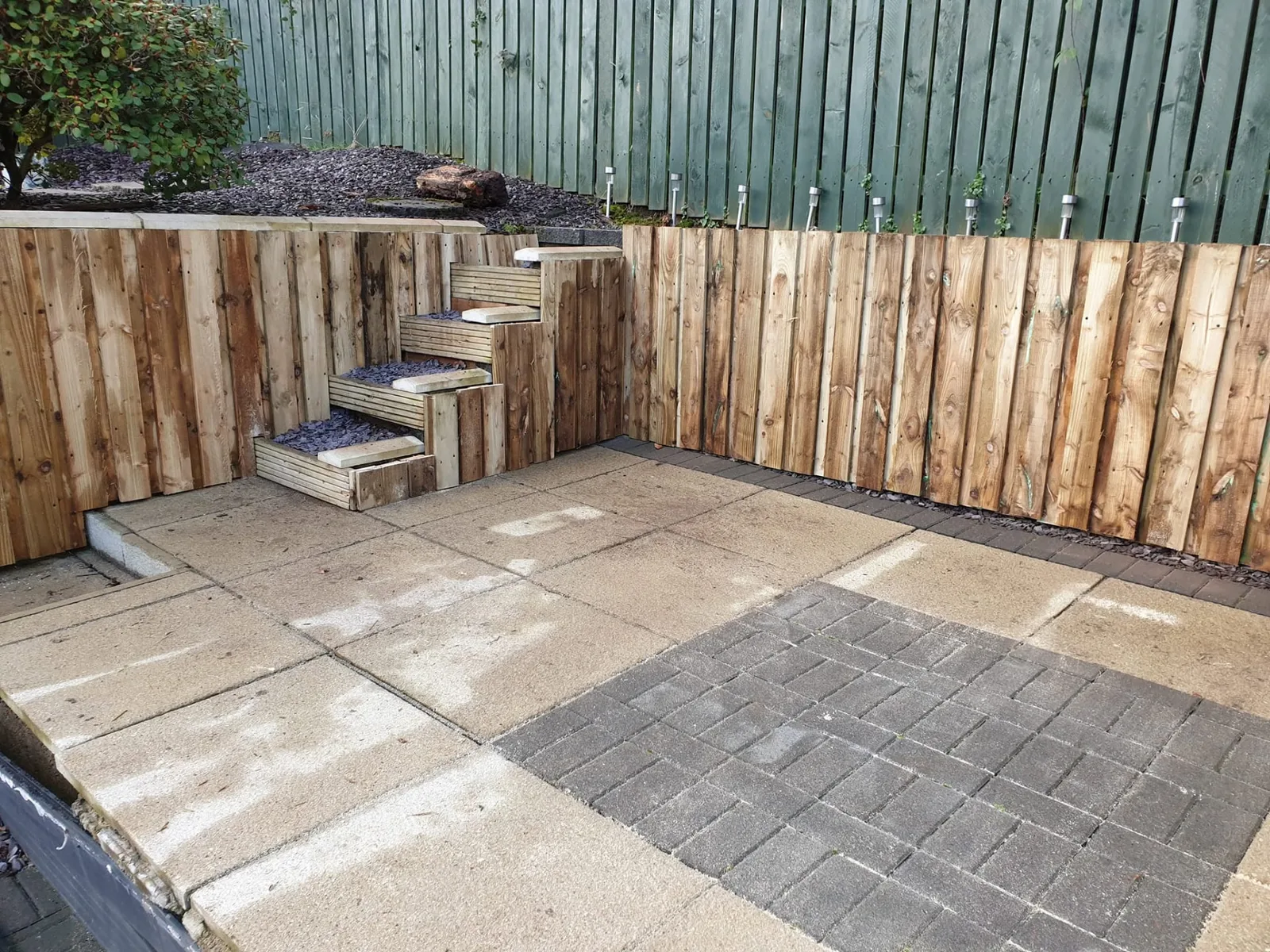 Timber boundary work and steps alongside a paved area